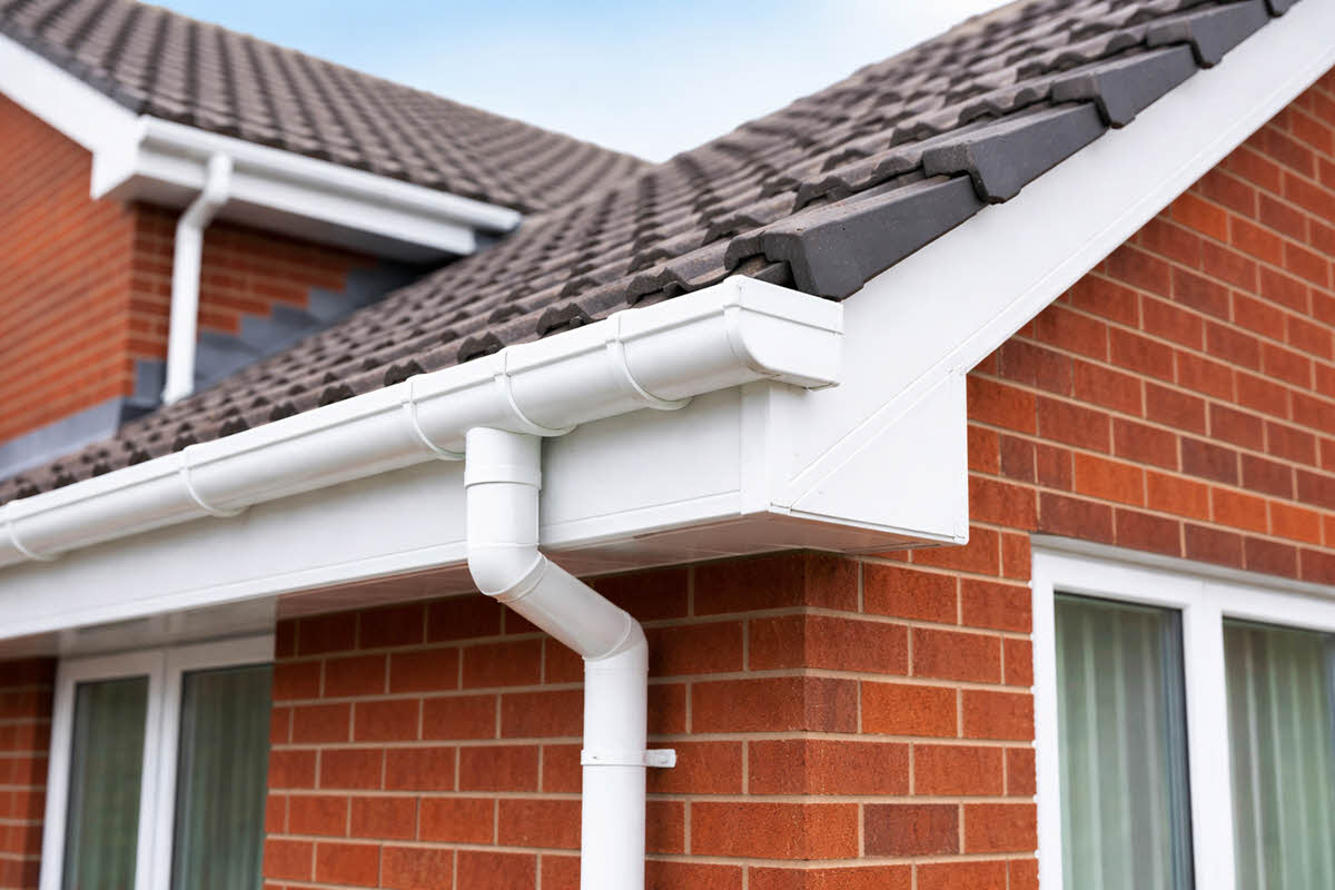 new build estate homes with close up of bungalow roofline guttering